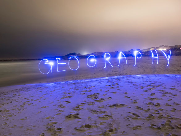 "Geography" spelled out in lights at night.