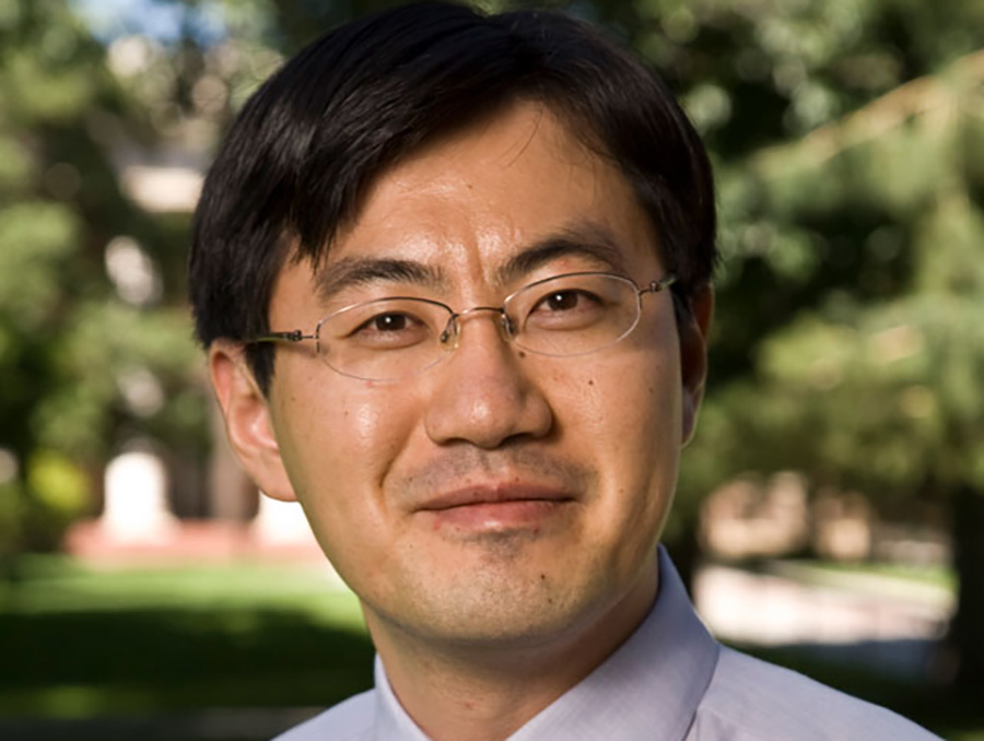 Headshot of Professor Jihwan Yoon in front of trees and grass.